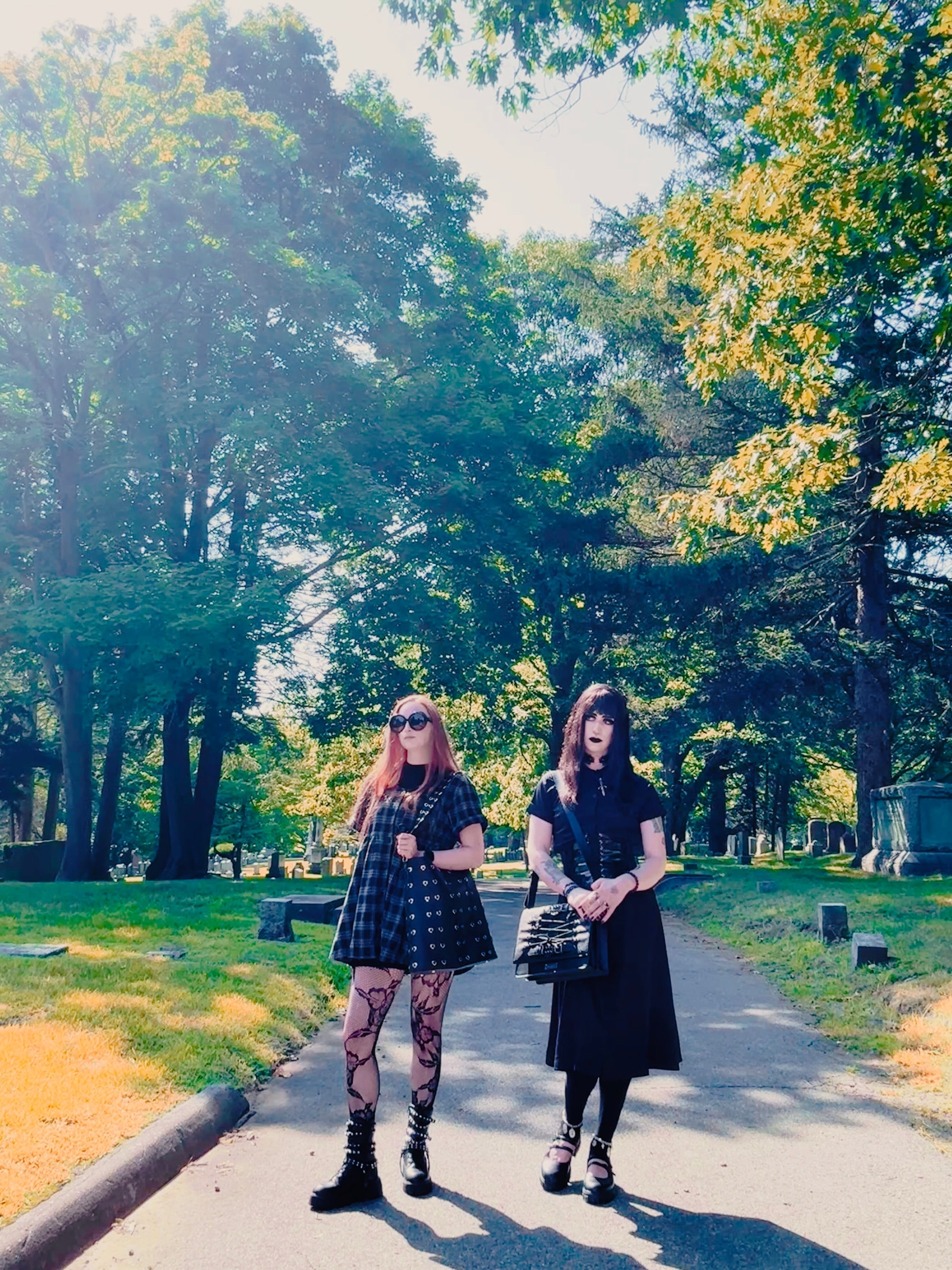 Fall goth plaid dark academia and grunge aesthetic outfits in a cemetery in Salem